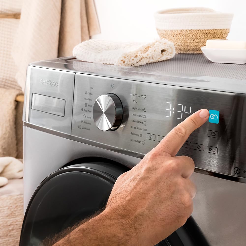 Hand turning the program selection dial on the washing machine's control panel