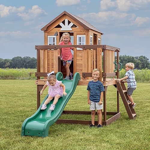 Image of Backyard Discovery Echo Heights Elevated Cedar Wooden Kids Playhouse with Wave Slide, Play Kitchen, Wrap-Around Deck, Flat-Step Ladder, Half Door, Windows, Bell, and Growth Chart for Outdoor Play