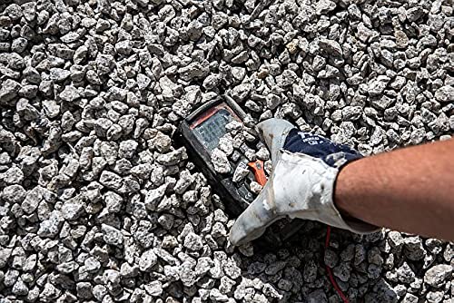 Sonel CMM 30 Multimeter partially buried in gravel, demonstrating its rugged construction and dust resistance.