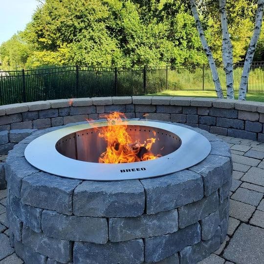 Breeo Zentro Fire Pit Insert with a fire burning inside a block surround