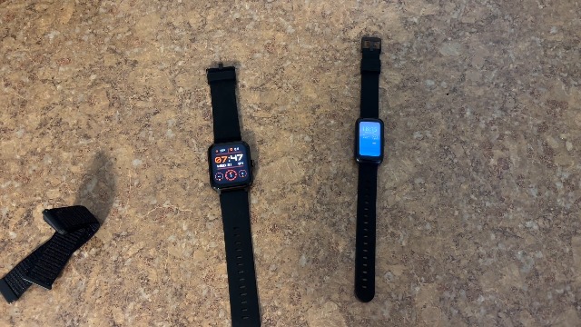 Two fitness trackers side-by-side, one of which is the RLQA Fitness Tracker Band 2.