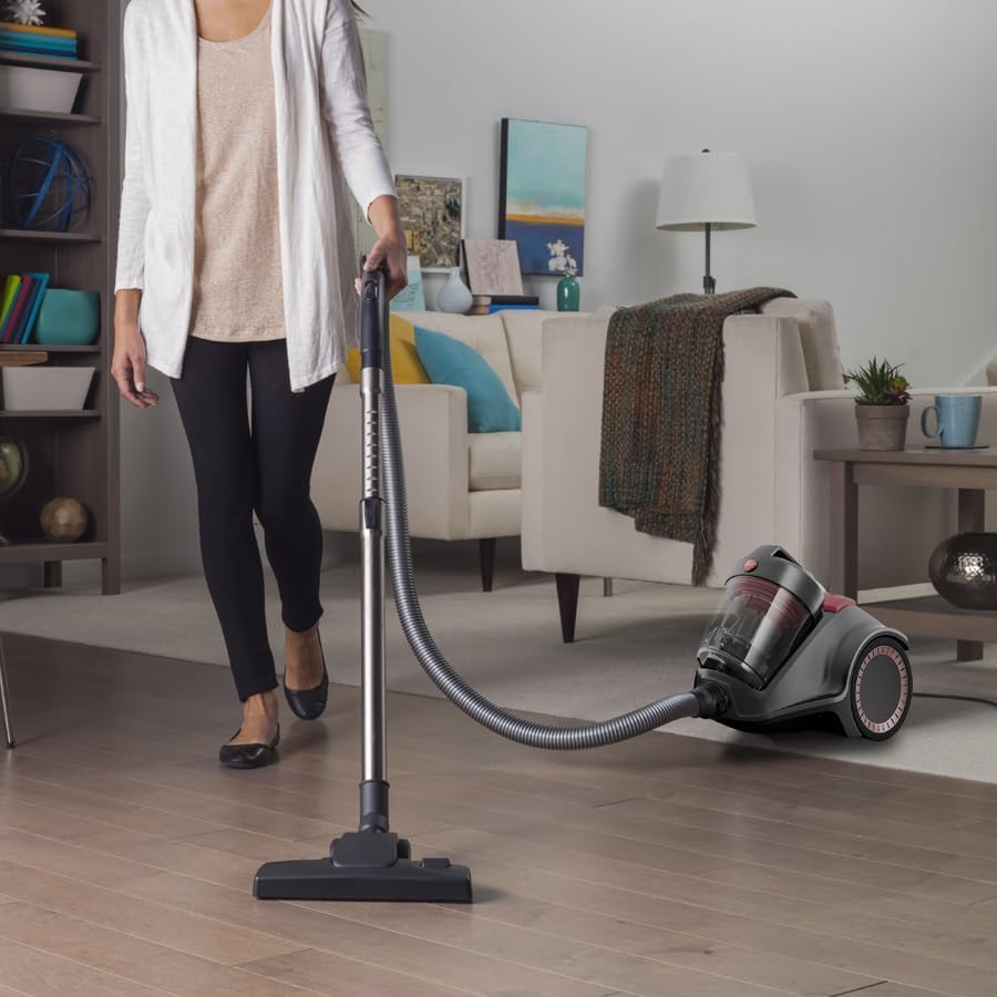 Woman vacuuming a carpeted floor with the Hoover Power 6 Advanced