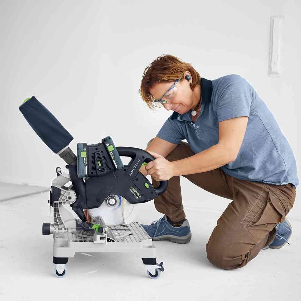 User operating Festool miter saw with dust collection bag