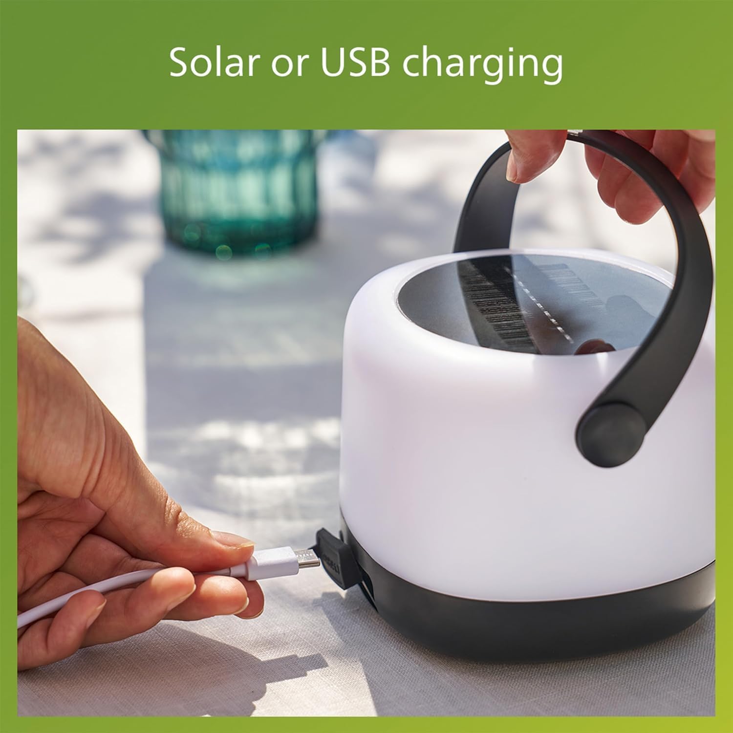 Hand plugging a USB cable into the Philips LED Solar Portable Light