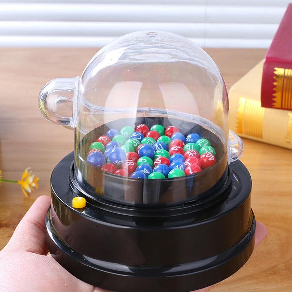 Hand pressing the yellow button on the TOYANDONA Electric Shake Lucky Ball Machine