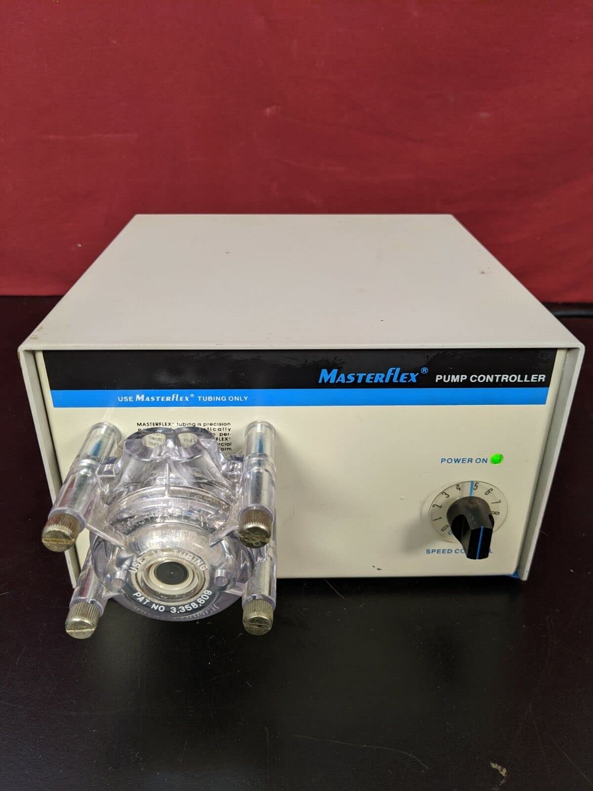 Control panel of the Masterflex pump with a green 'POWER ON' indicator light and a speed control knob.