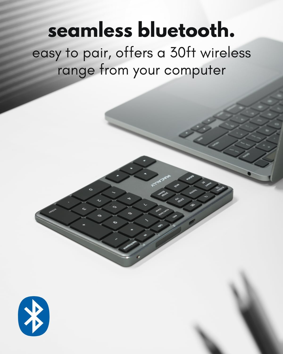 Macally Bluetooth Number Pad next to a laptop, showing wireless connection