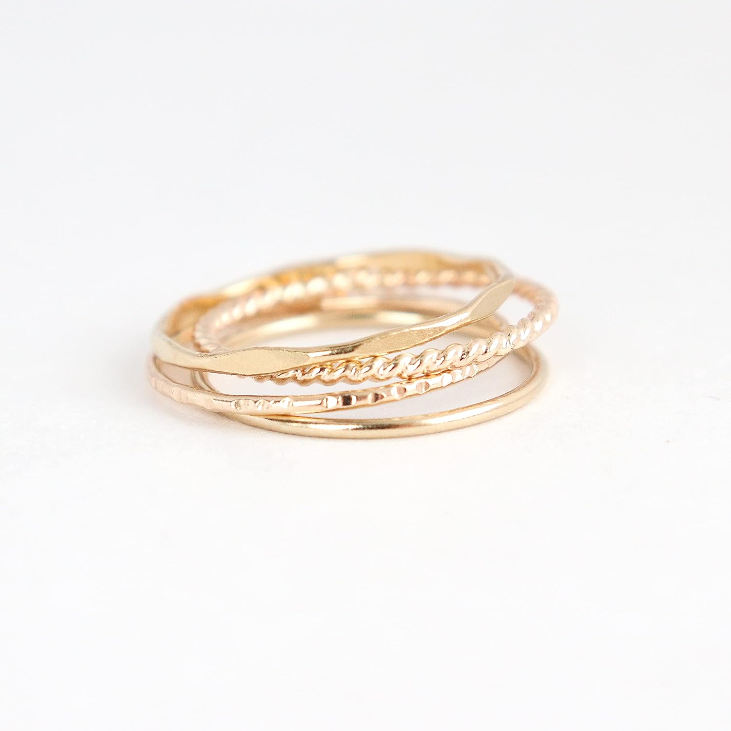 14k yellow gold filled stacking rings. minimalist metal stack bands set of four (4). various texture options - smooth, hammered, stardust, twist, or pebbled