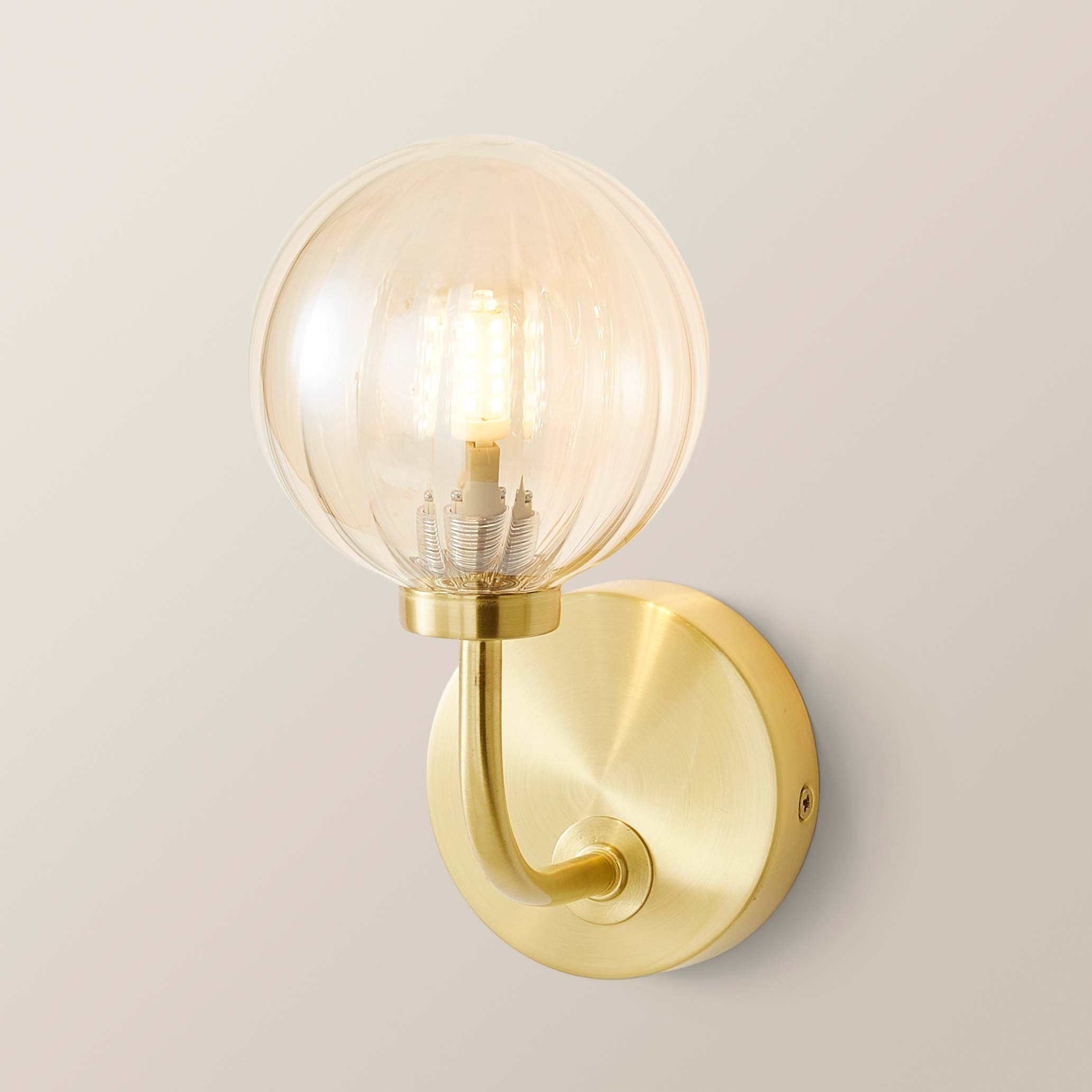 Valuelights Chessy Gold Metal Curved Wall Light With Amber Ribbed Glass Globe Shade from B&Q