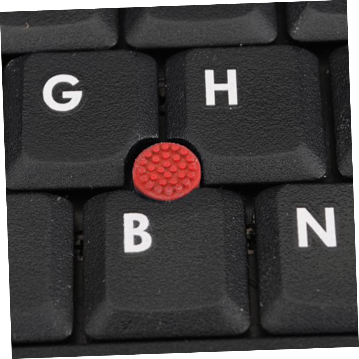 Close-up of a single red mouse cap, showing its textured surface and the hollow underside designed to fit onto a TrackPoint stem.