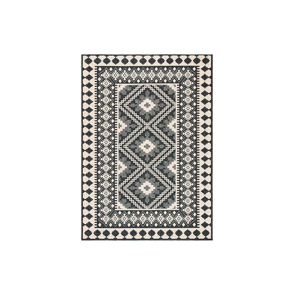 Petit canapé chambre ado complété par un tapis doux gris noir