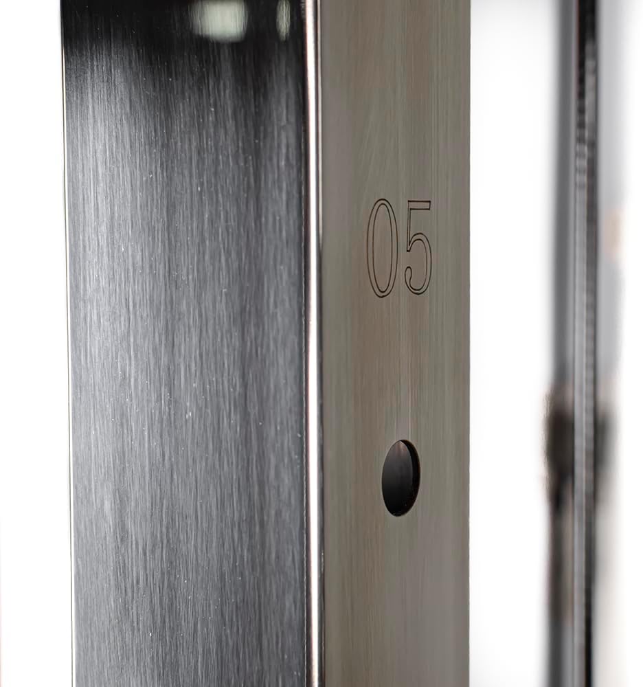 Close-up of a metal frame component with '05' etched on it.