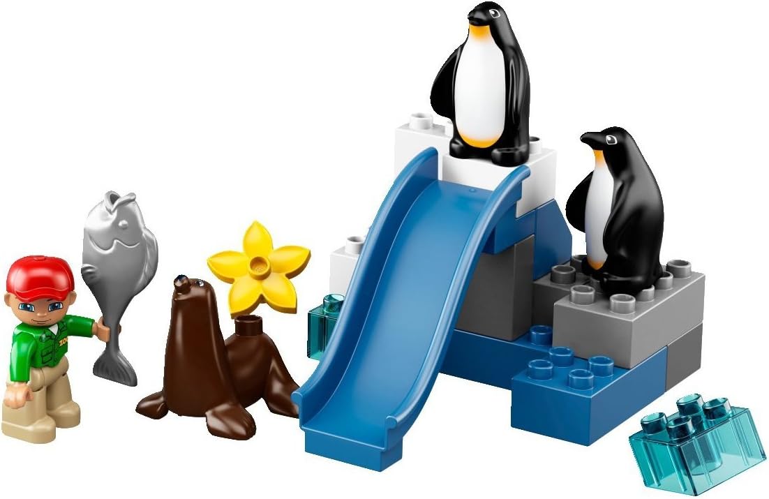 Assembled LEGO DUPLO penguin playground with two penguins, a blue slide, and ice-like bricks.