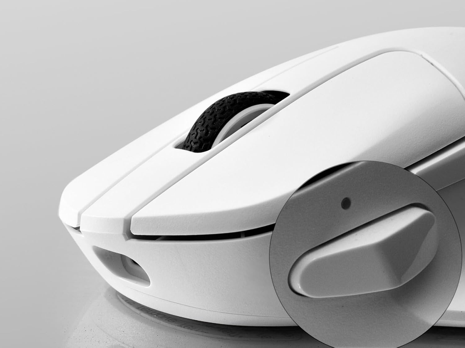 Close-up of the Keychron M7 mouse showing the mode switch on the bottom.