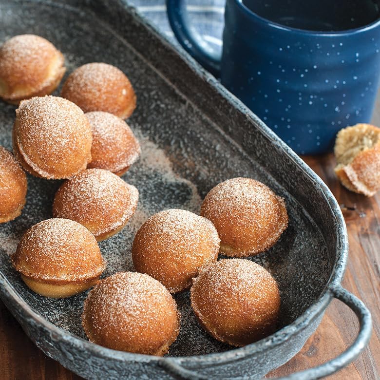 Baked donut holes in a pan, dusted with sugar