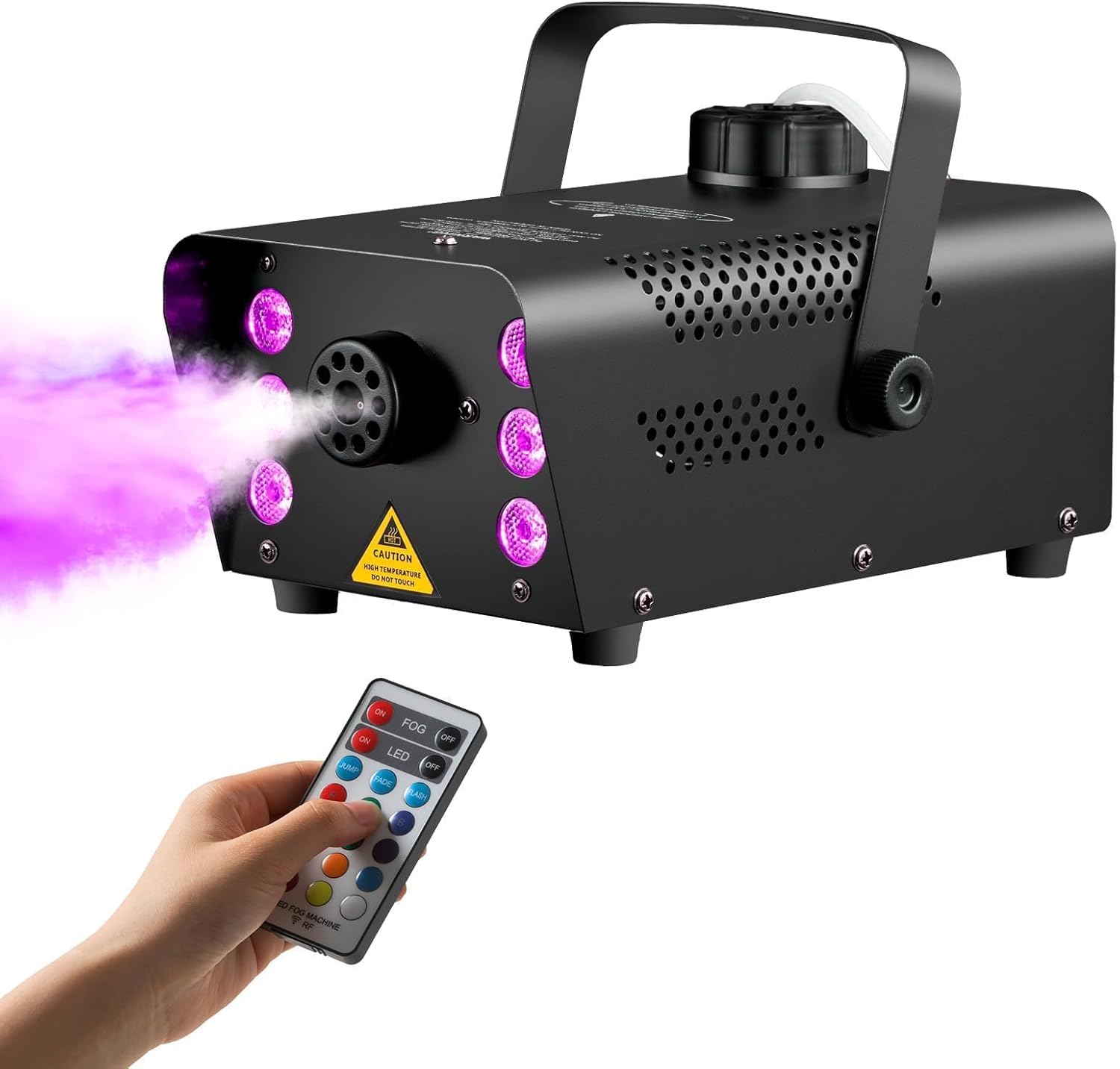 A hand holding the wireless remote control, activating the Sunolga fog machine which emits purple-colored fog.