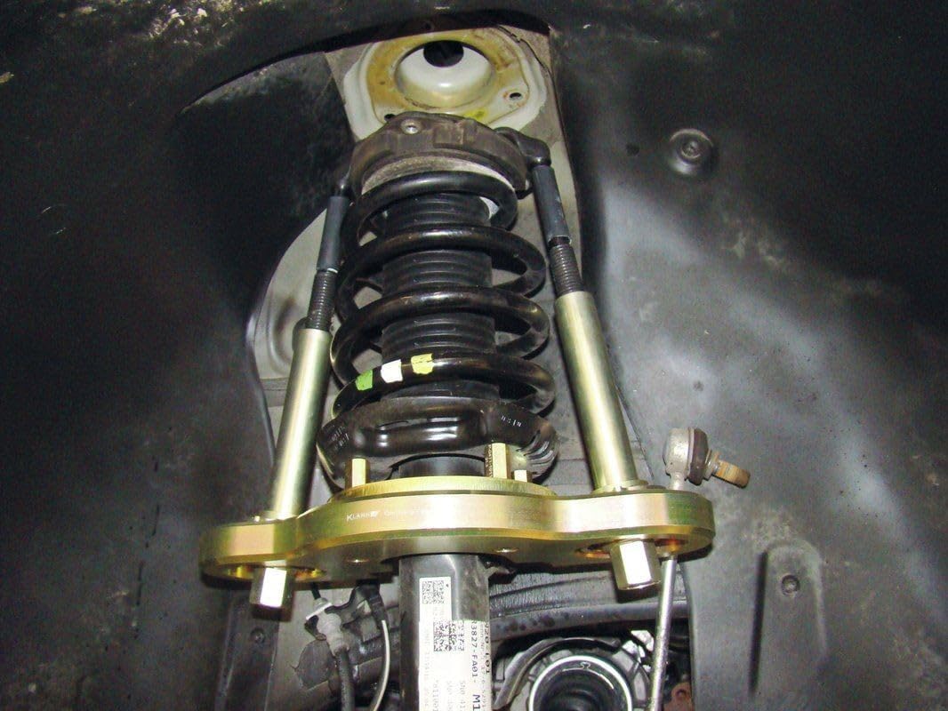 GEDORE Spring Preload Tool Extension Kit installed on a vehicle strut