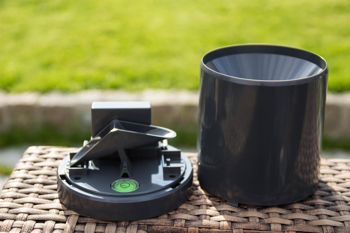 Interno view of the POPP Z-Rain sensor showing the tipping bucket mechanism and a bubble level.