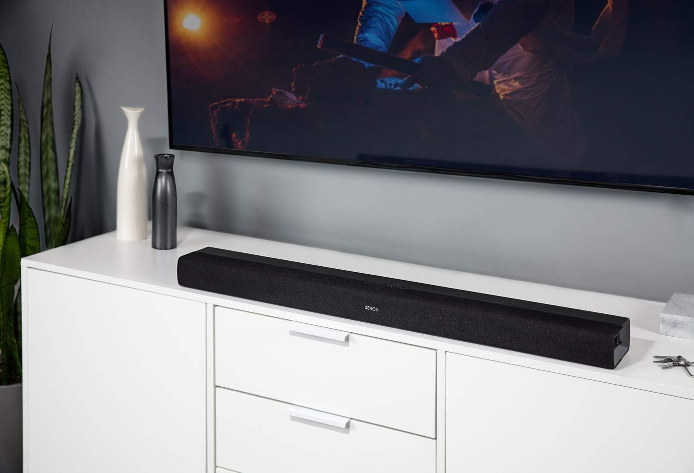 Denon DHT-S216 soundbar placed on a TV cabinet