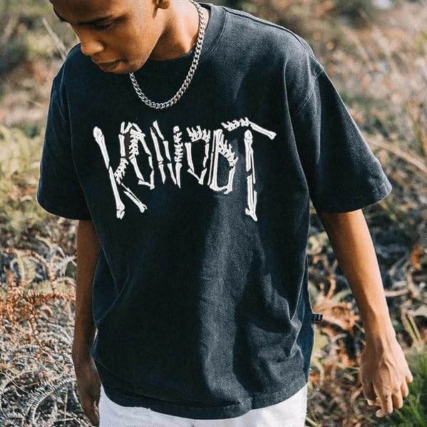 A person wearing the KONOOT Vintage Skeleton Design Graphic T-Shirt outdoors, demonstrating its casual wearability.