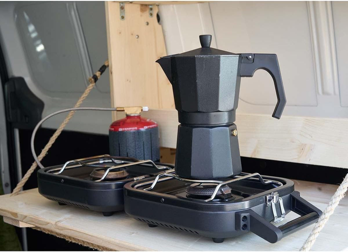 The KEMPER 104981N 2-burner gas stove in operation, with both burners emitting a steady blue flame, indicating proper ignition and gas flow.