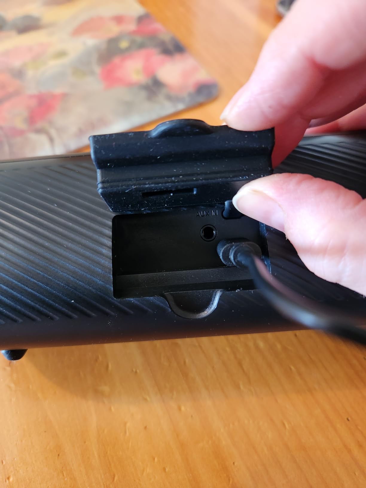 Rear flap open revealing USB-C charging port and AUX port on BolaButty speaker