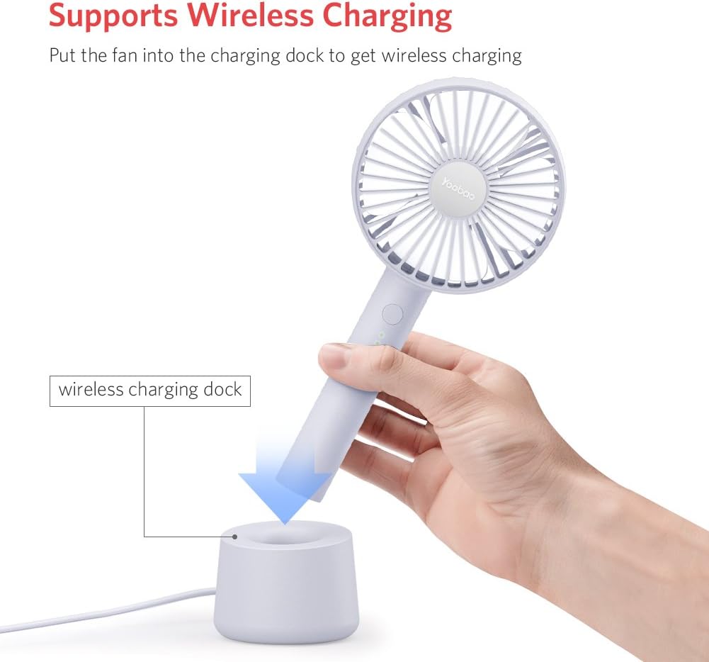 Yoobao Portable USB Handheld Fan F02-BE being placed into its wireless charging dock