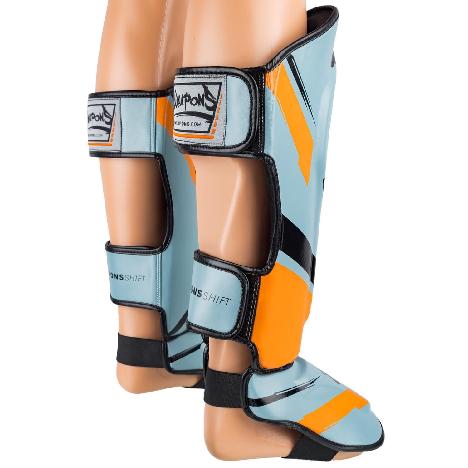 8 WEAPONS Espinilleras Shift, color gris hielo naranja, entrenamiento y competición, piel sintética de alta calidad y amortiguación perfecta, Muay Thai, K1, MMA, karate y kickboxing