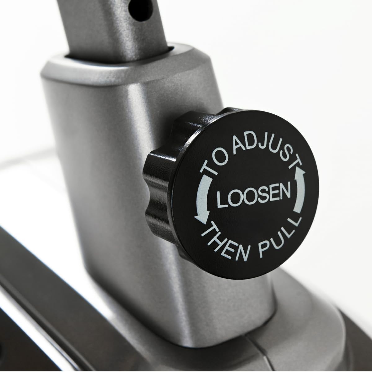 Adjustment knob for the TOORX BRX-75 EASY exercise bike, showing 'TO ADJUST LOOSEN THEN PULL' instructions.