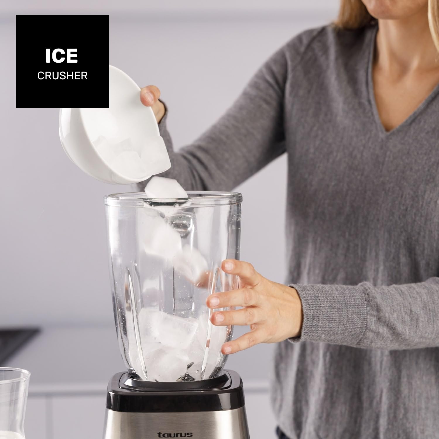 Woman pouring smoothie from blender into glass