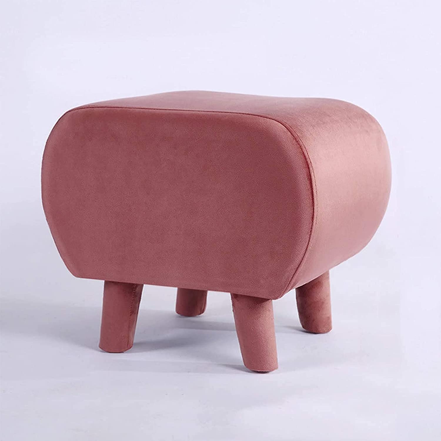 Pouf repose-pieds rose pour créer un coin détente près de la table basse