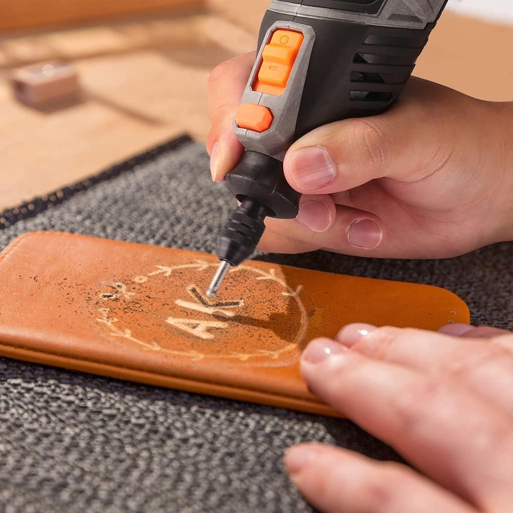 Rotary tool with a sanding drum attachment being used to sand a piece of wood