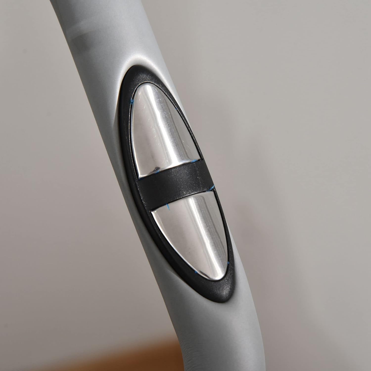 Close-up of the heart rate sensor pads on the handlebars of the exercise bike