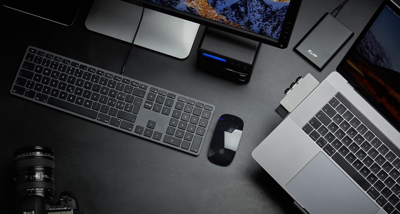 LMP USB Keyboard integrated into a Mac desktop setup, alongside a mouse, monitor, and other peripherals, demonstrating its compatibility and aesthetic fit.