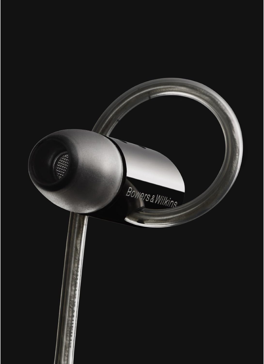 Close-up of a person's ear with the Bowers & Wilkins C5 earbud properly inserted, showing the Secure Loop in place.