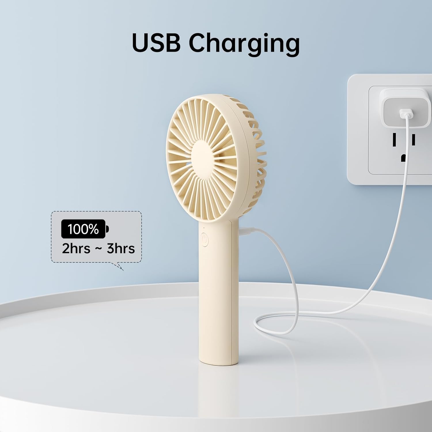 JISULIFE Handheld Portable Mini Fan charging via USB cable.