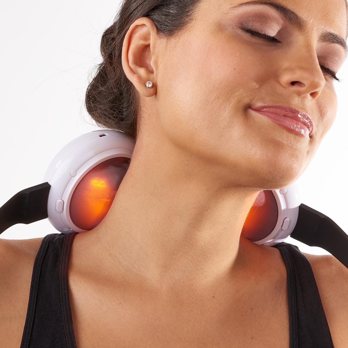 A person using the Sharper Image 3D Shiatsu Neck and Shoulder Massager on their neck, with the heat function visibly active.