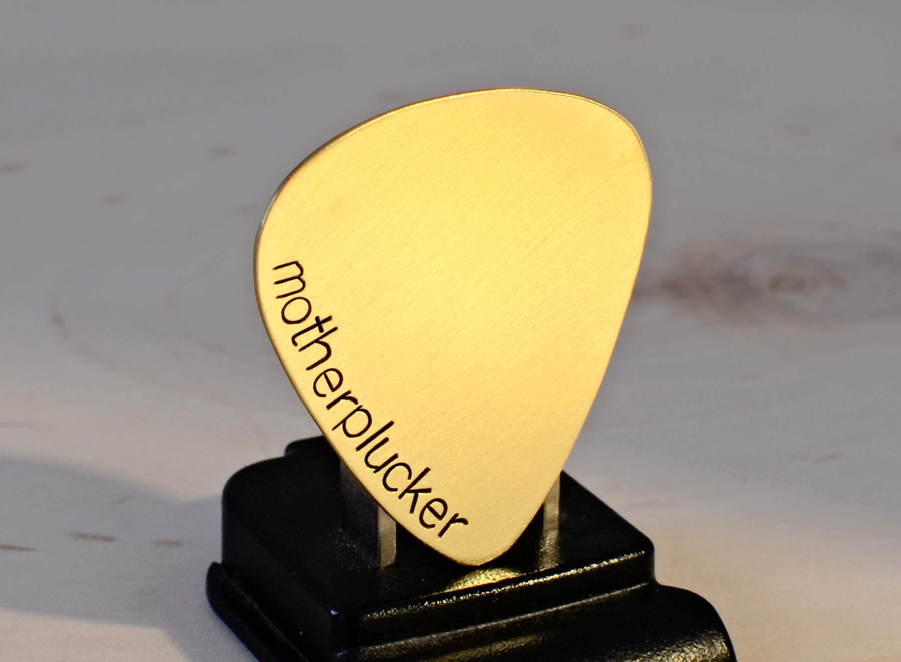 Mother plucker brass guitar pick