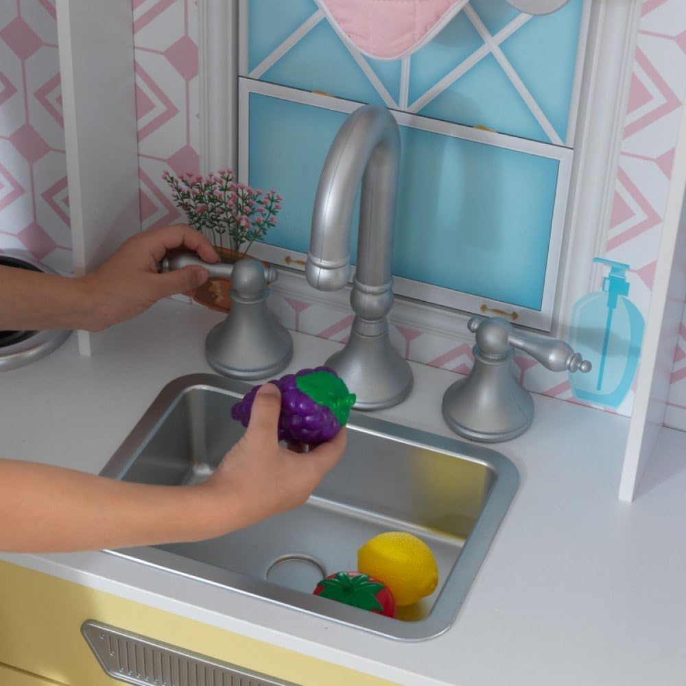 Child washing play fruit in removable sink