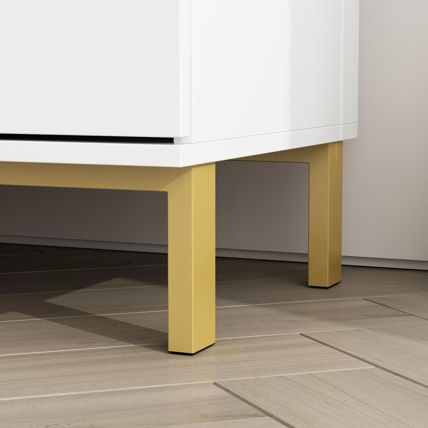 Close-up view of the gold metal legs of the FUFU&GAGA White Nightstand, showing their sturdy construction.