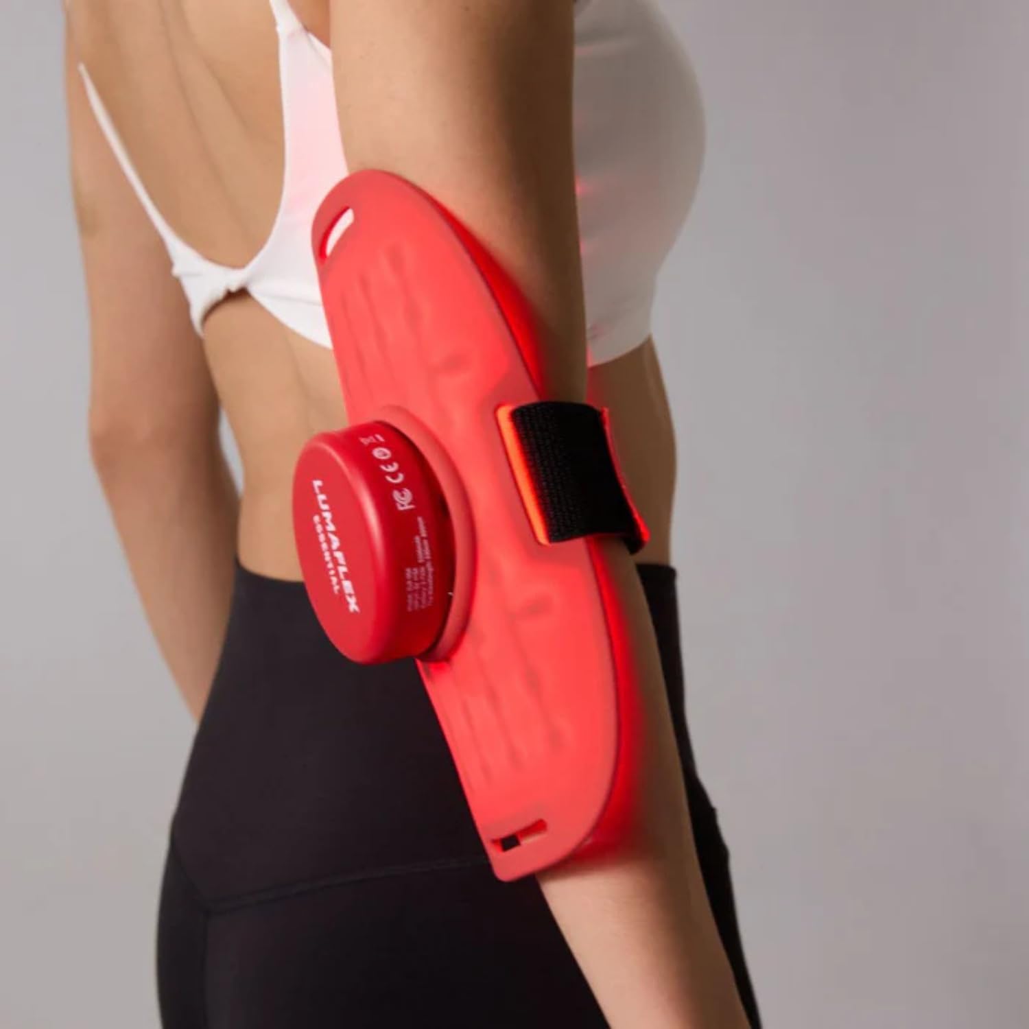 Lumaflex Essential Red Light Therapy device strapped to a person's arm.