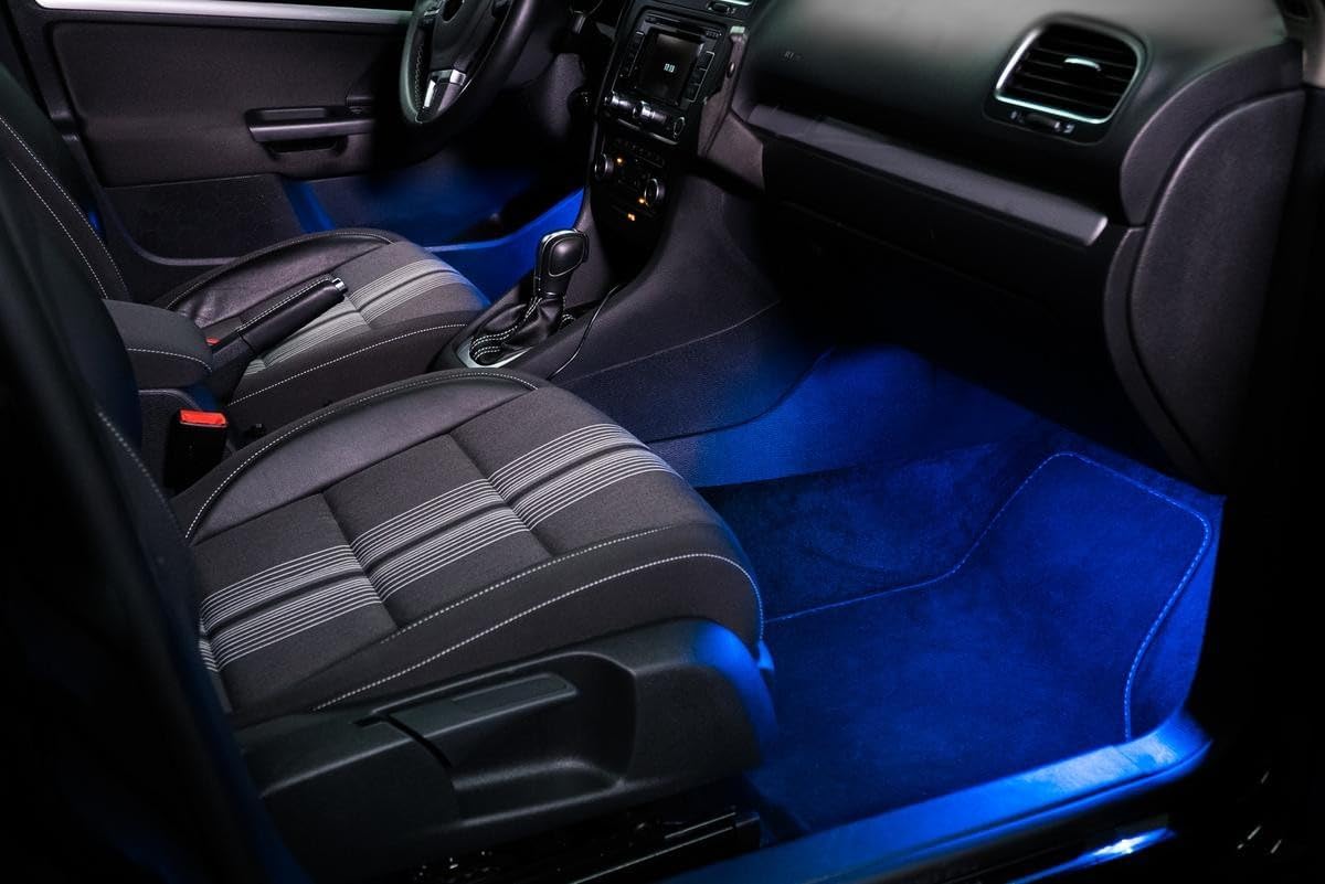Vehicle interior with OSRAM LEDambient Tuning Lights installed, illuminating the footwell in blue.