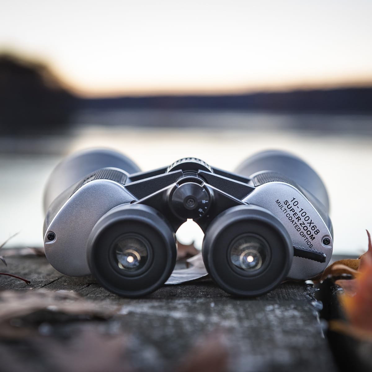 Close-up of Sharper Image 100X Ultrazoom Binoculars on a wooden surface