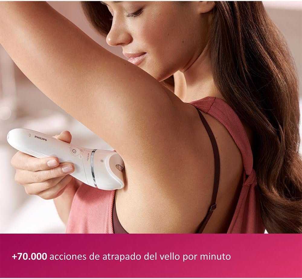 Woman using Philips epilator on underarm