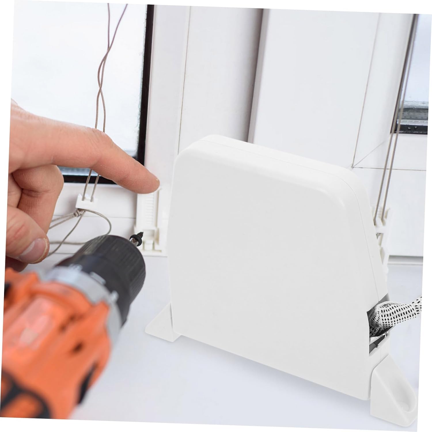 Close-up of blind cord being fed into winder