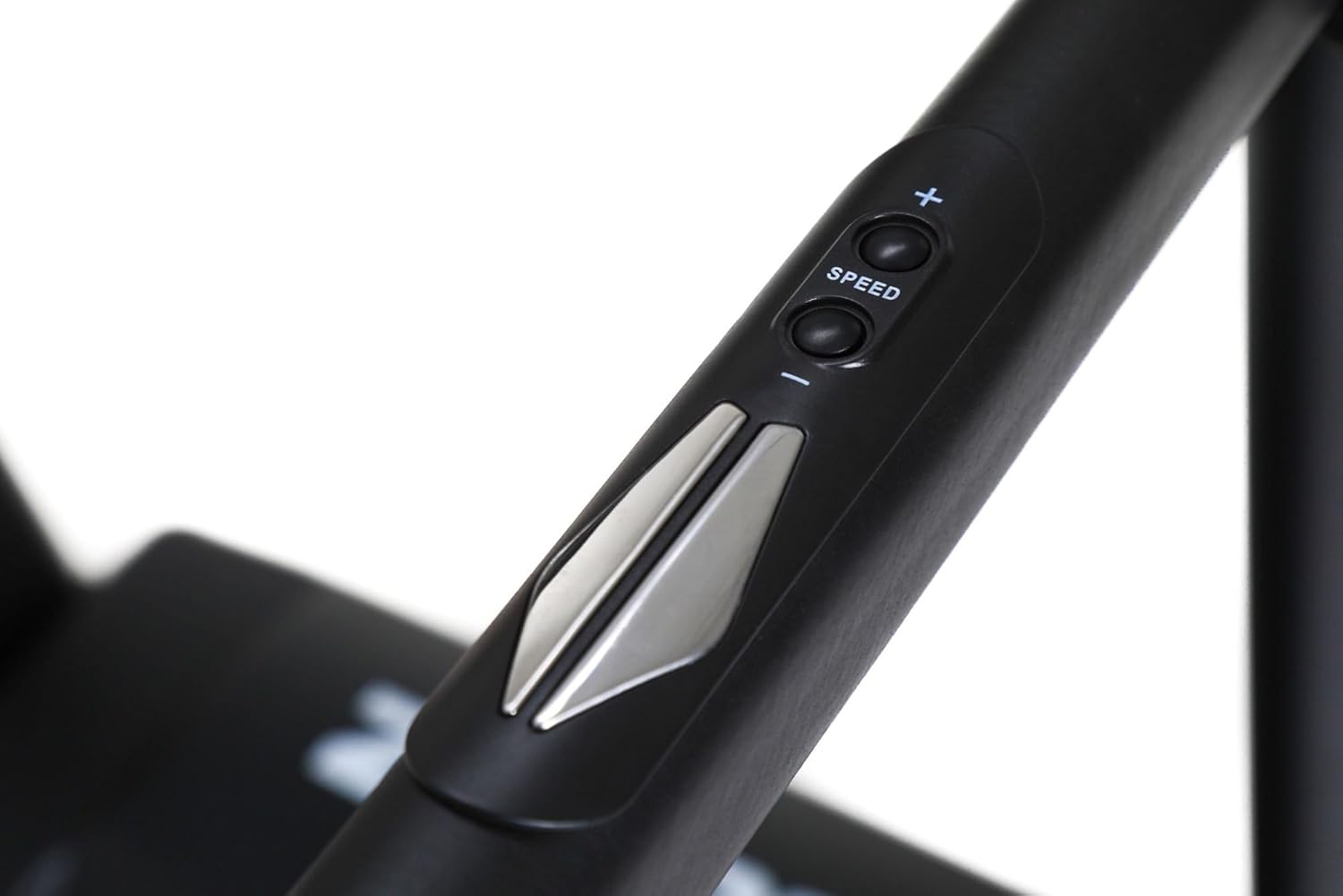 Close-up of speed and incline control buttons on the treadmill handrail
