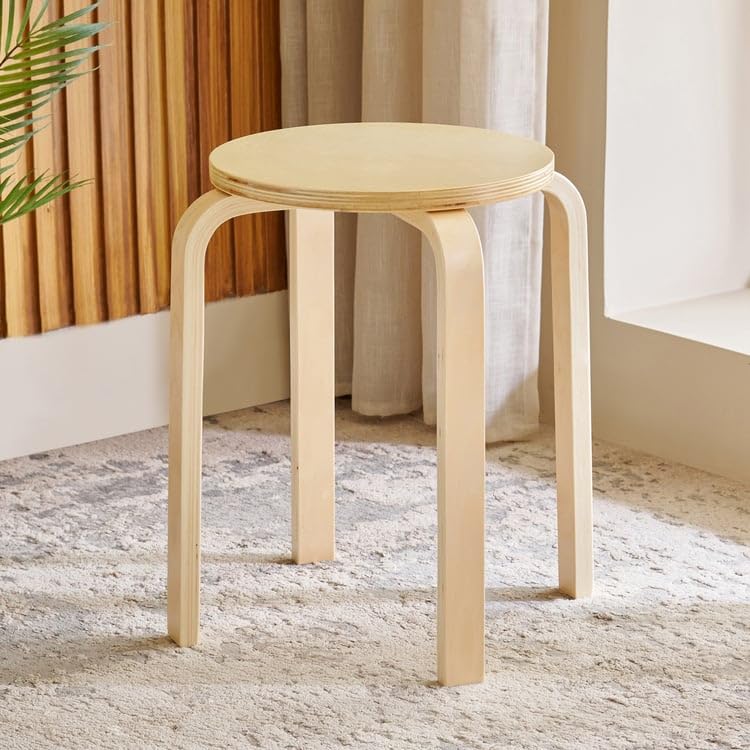 Home Centre Paulo Solid Wood Stool with dimensions shown next to a person for scale