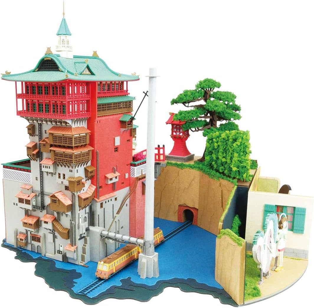 Side view of the fully assembled Sankei Spirited Away Diorama, showing the intricate details of the bathhouse, a train on tracks, and a river.
