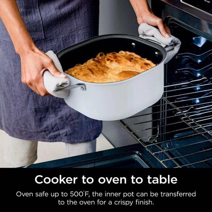 A person transferring the cooking pot from the PossibleCooker into an oven, highlighting its oven-safe feature.