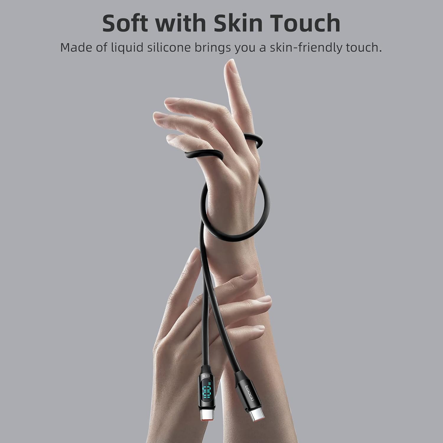 A hand holding the soft-touch silicone USB C cable, emphasizing its texture